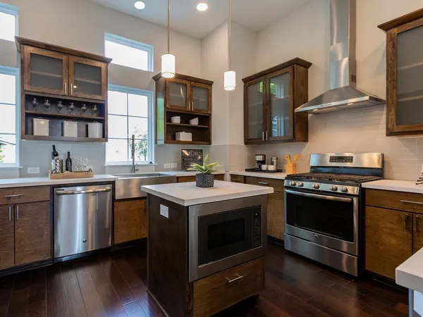 a kitchen with stainless steel appliances granite countertop a stove and a sink
