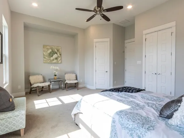 a spacious bedroom with a bed and a couch