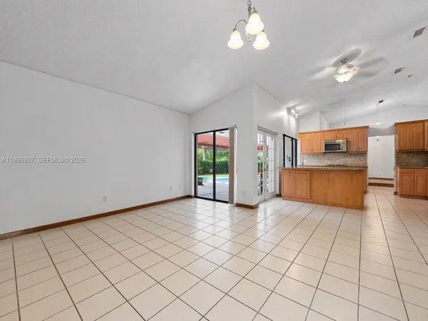 a kitchen with stainless steel appliances granite countertop a refrigerator and a stove
