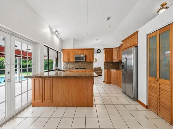 a kitchen with stainless steel appliances granite countertop a stove and a sink