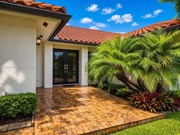 a view of a house with a yard and plants