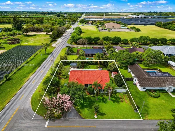 an aerial view of a house with a garden and swimming pool