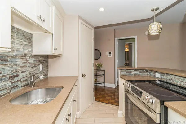 a kitchen with a sink stove and cabinets