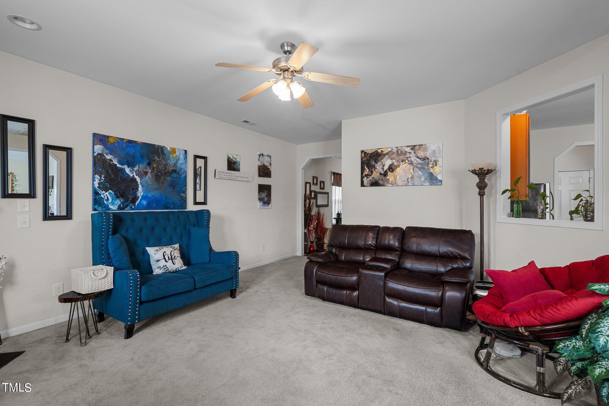 3930 Evans Drive Raleigh, NC 27610 - Photo 12 of 44 a living room with furniture and a mirror