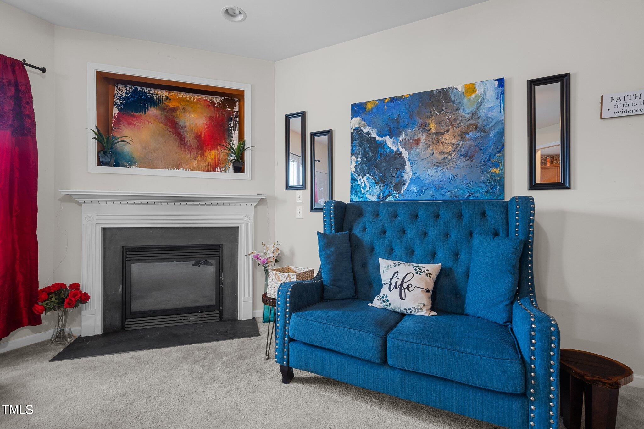 3930 Evans Drive Raleigh, NC 27610 - Photo 13 of 44 a living room with furniture and a fireplace