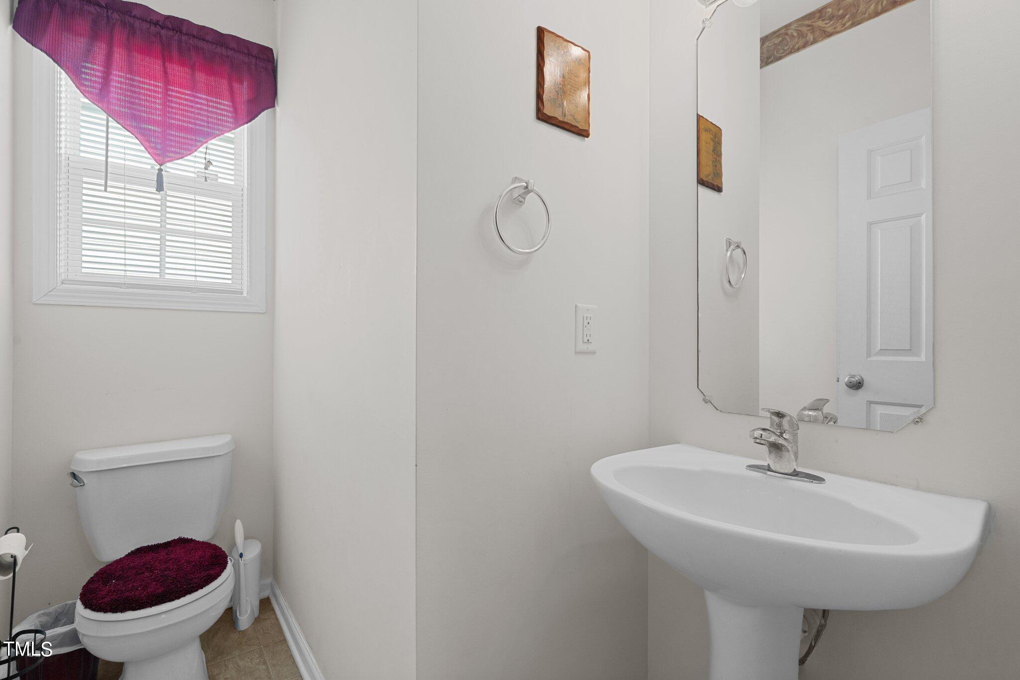 3930 Evans Drive Raleigh, NC 27610 - Photo 15 of 44 a bathroom with a sink toilet and a mirror