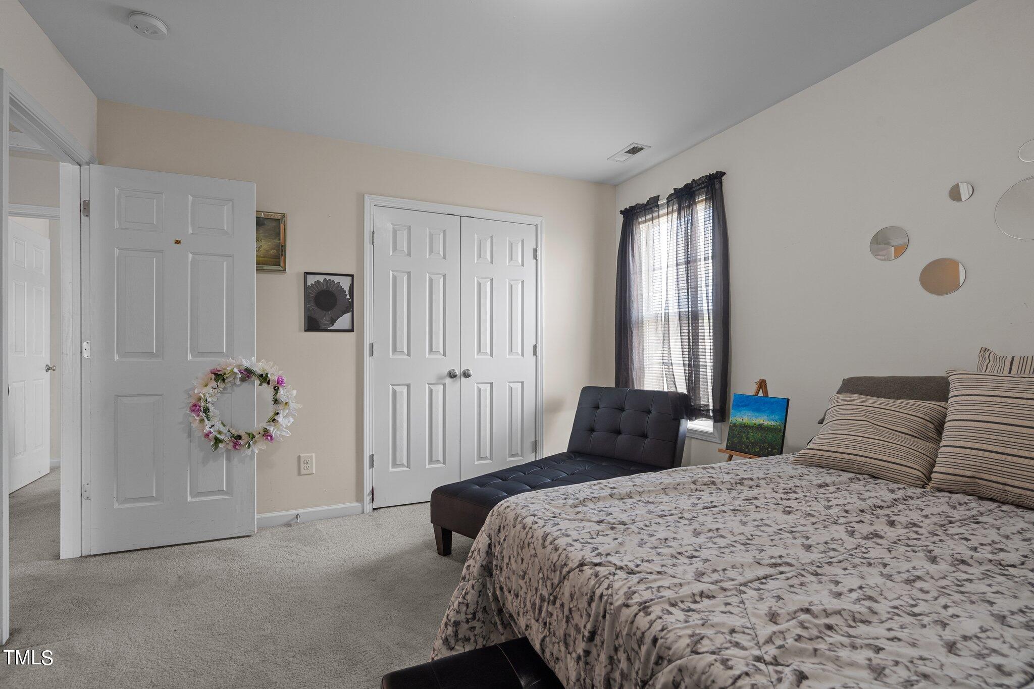 3930 Evans Drive Raleigh, NC 27610 - Photo 25 of 44 a bedroom with a bed and a window