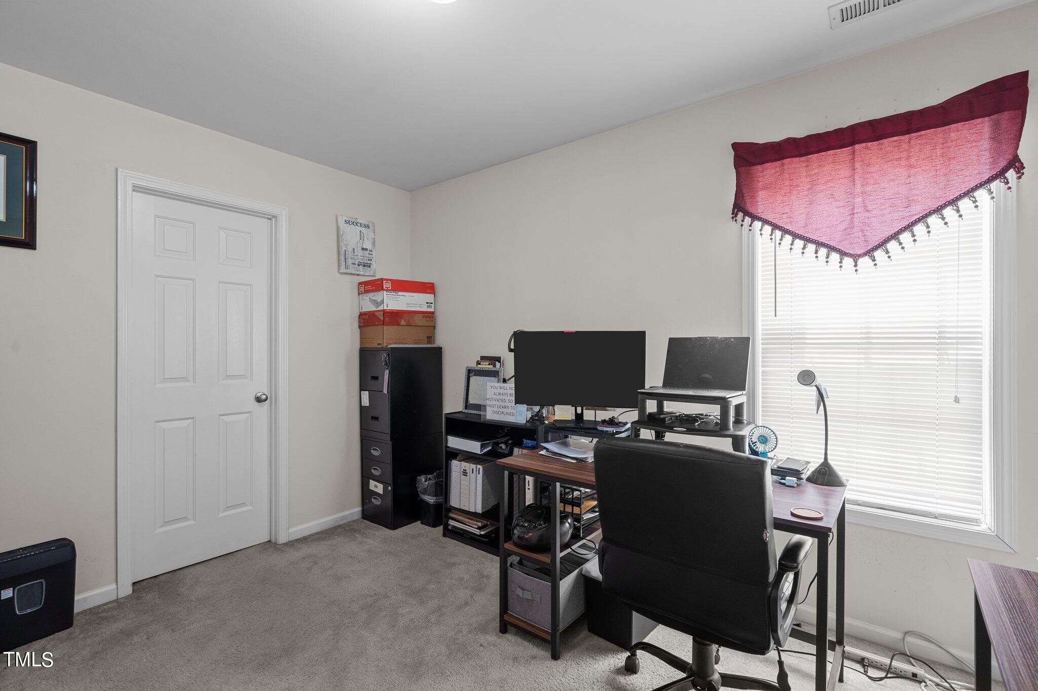 3930 Evans Drive Raleigh, NC 27610 - Photo 30 of 44 a view of a workspace with furniture and a window