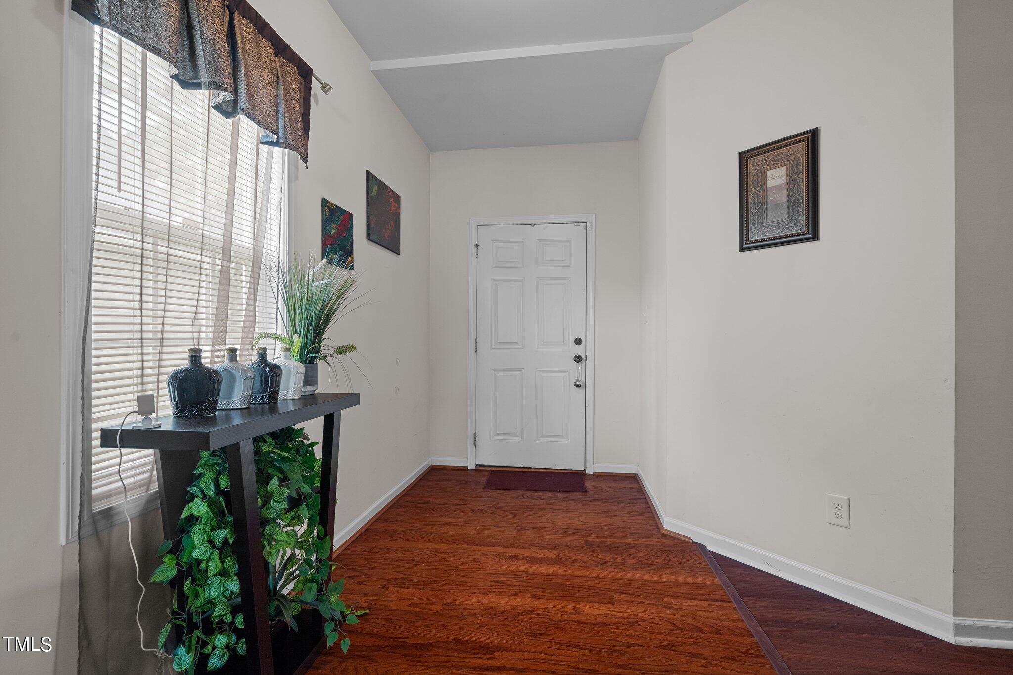 3930 Evans Drive Raleigh, NC 27610 - Photo 3 of 44 a view of empty room with wooden floor and fan