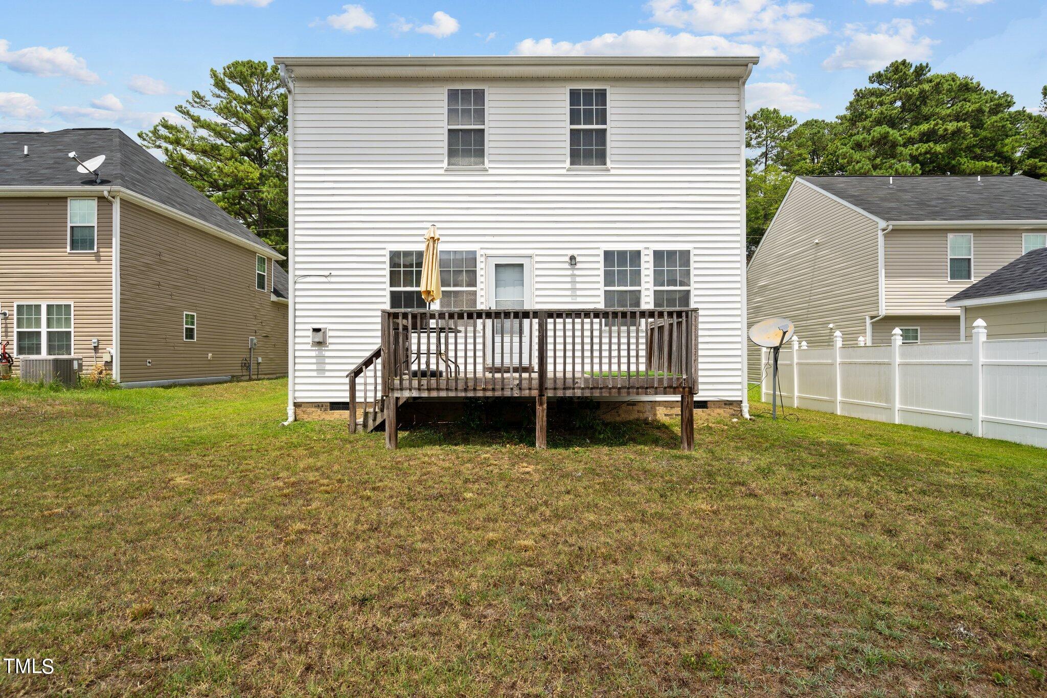 3930 Evans Drive Raleigh, NC 27610 - Photo 31 of 44 a view of a house with backyard and deck