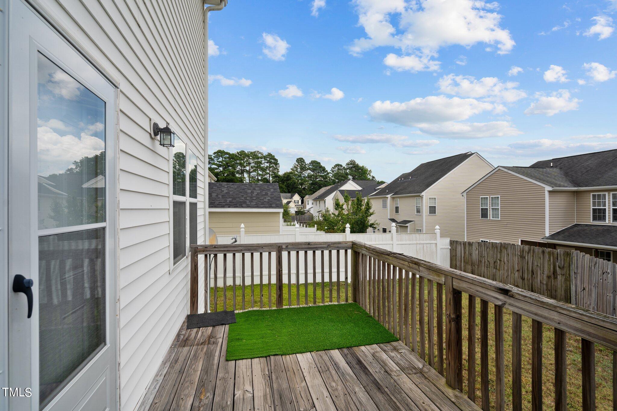3930 Evans Drive Raleigh, NC 27610 - Photo 32 of 44 a view of a wooden deck and a yard