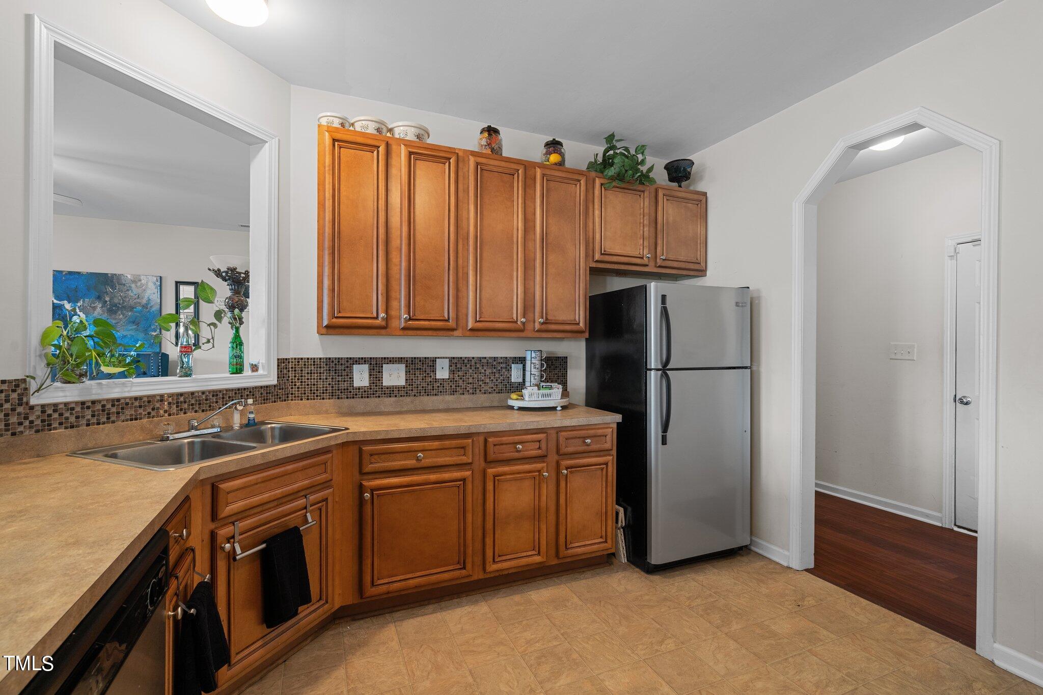3930 Evans Drive Raleigh, NC 27610 - Photo 7 of 44 a kitchen with stainless steel appliances granite countertop a refrigerator and a sink