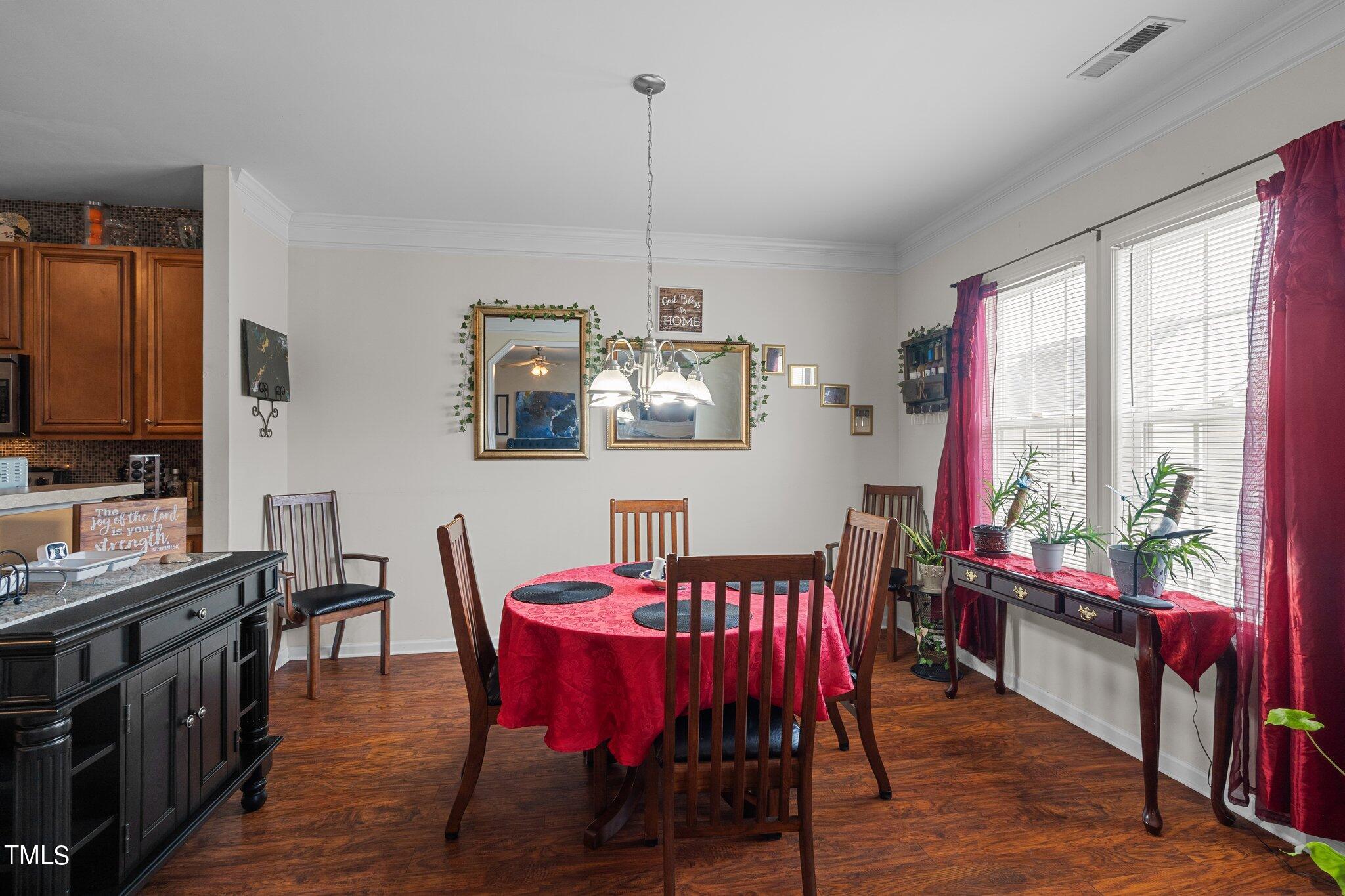 3930 Evans Drive Raleigh, NC 27610 - Photo 10 of 44 a view of a dining room with furniture window and wooden floor