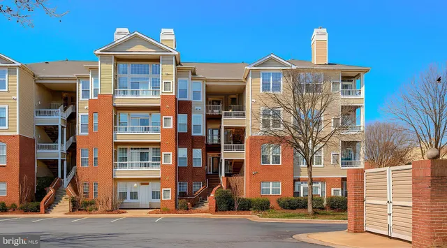 a front view of a residential apartment building with a yard
