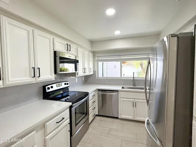a kitchen with a stove sink and microwave