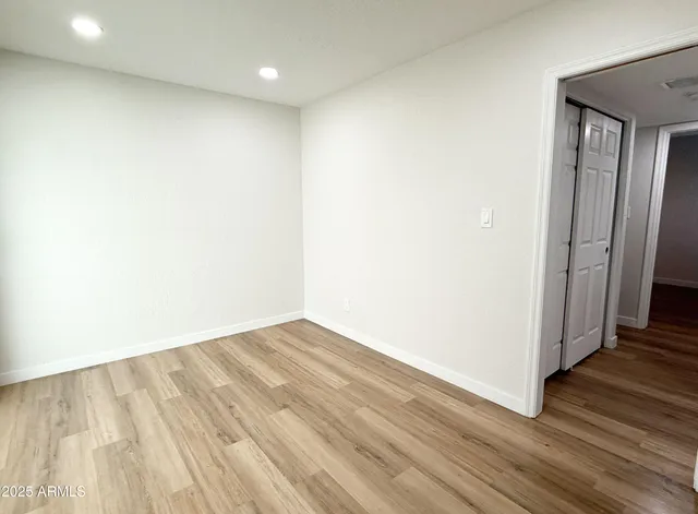 a view of hallway with wooden floor