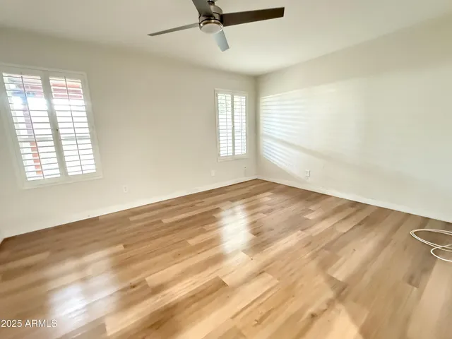 wooden floor in an empty room with a window