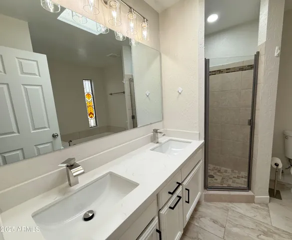a bathroom with a double vanity sink and a mirror
