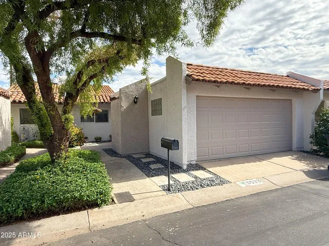 a front view of a house with a yard and garage