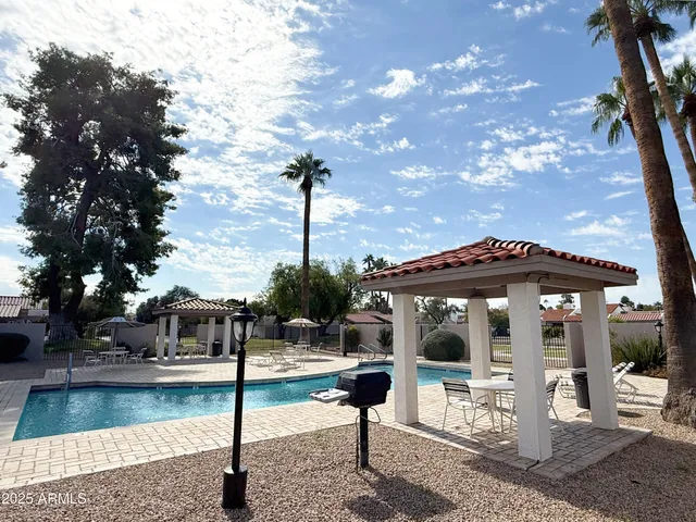 a view of a patio with a table chairs and a fire pit