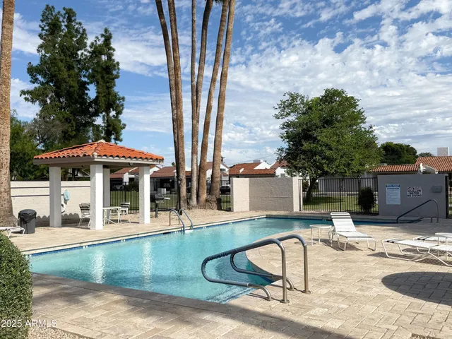 a view of a house with backyard and sitting area