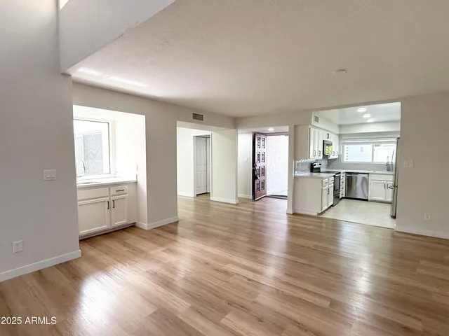 a view of a kitchen with wooden floor and a kitchen