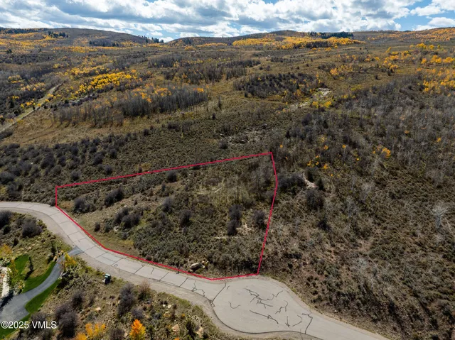 a view of a yard with wooden fence
