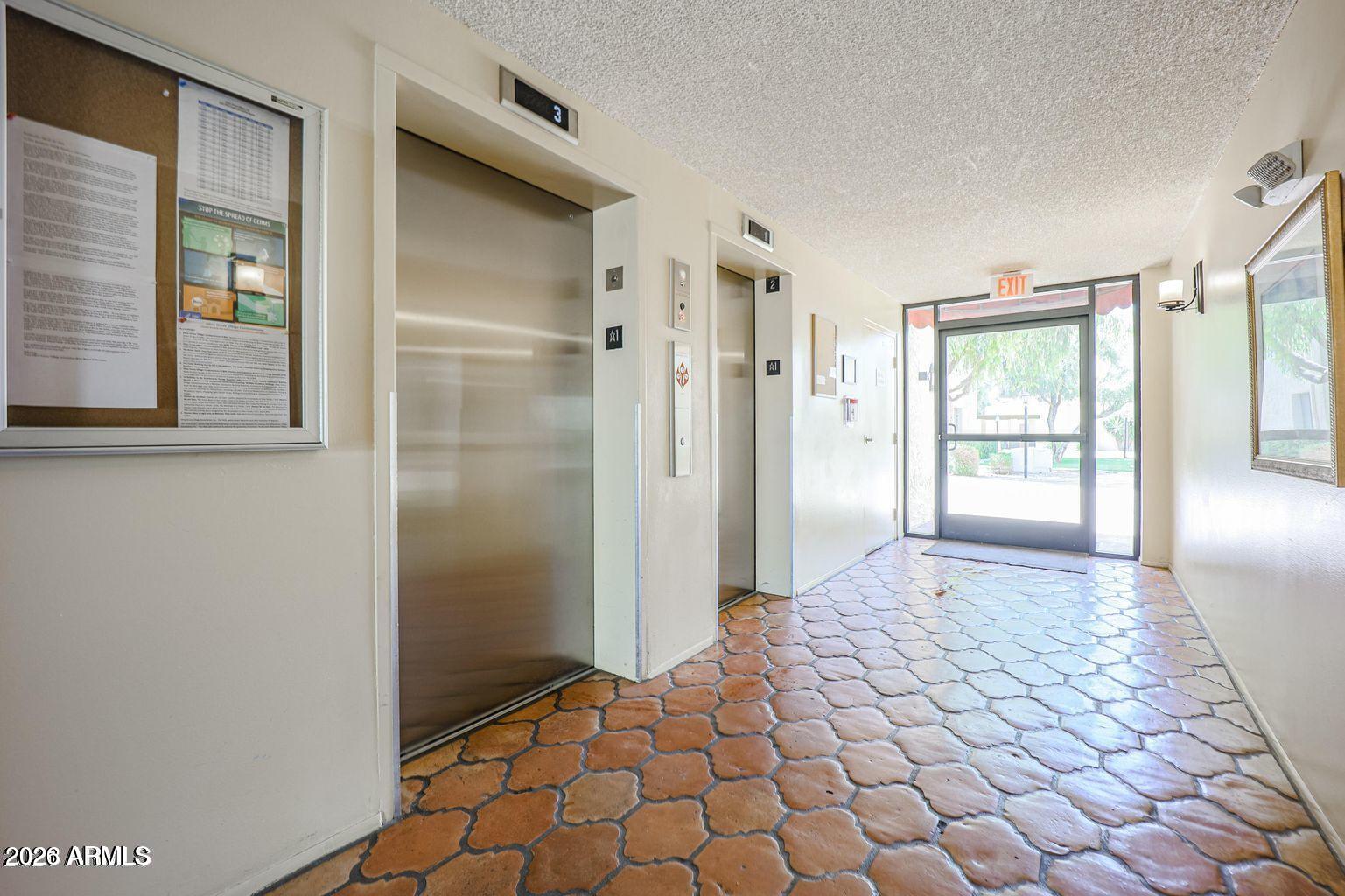 3033 East Devonshire Avenue, Unit 1018 Phoenix, AZ 85016 - Photo 28 of 56 OLIVE GROVE ELEVATORS GROUND LEVEL TO 2N