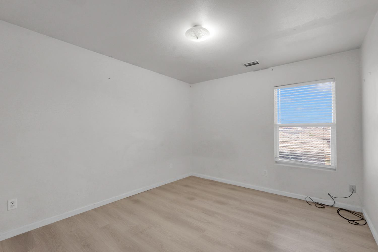 1412 Red Ribbons Lane Manteca, CA 95337 - Photo 20 of 32 an empty room with a window