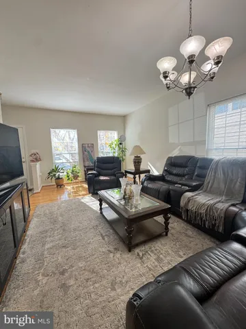 a living room with couches a fireplace and a flat screen tv