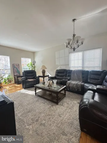 a living room with furniture and a chandelier