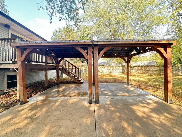 a view of house with outdoor space and deck