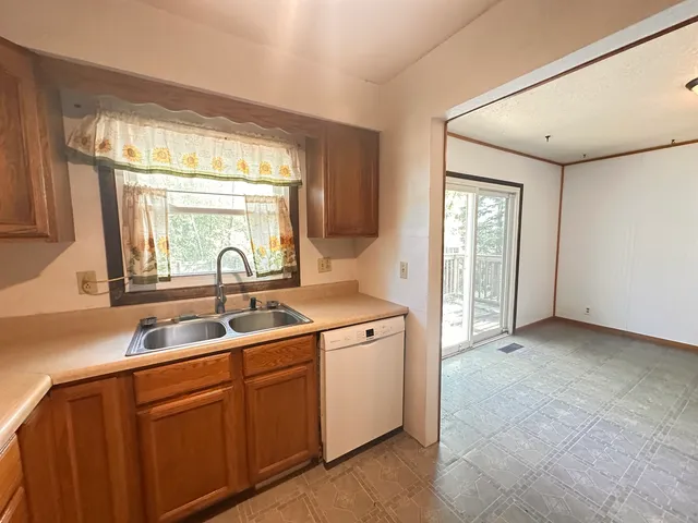 a kitchen with a sink and large window