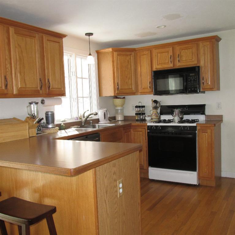 13 E Road Mashpee, MA 02649 - Photo 6 of 18 a kitchen with stainless steel appliances granite countertop a sink a stove a microwave a counter space and cabinets