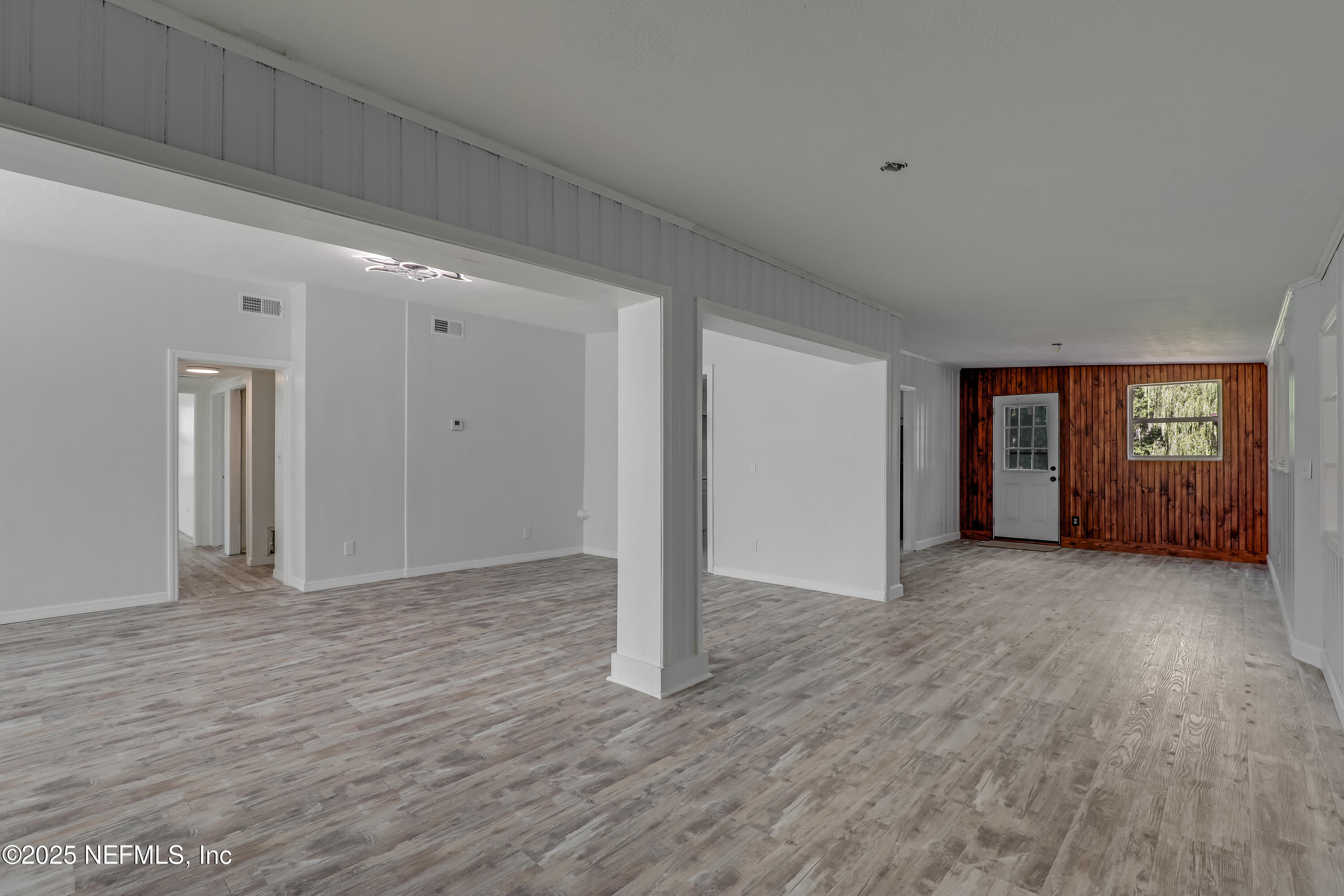 10524 Rutgers Road Jacksonville, FL 32218 - Photo 12 of 46 a view of an empty room with window and wooden floor
