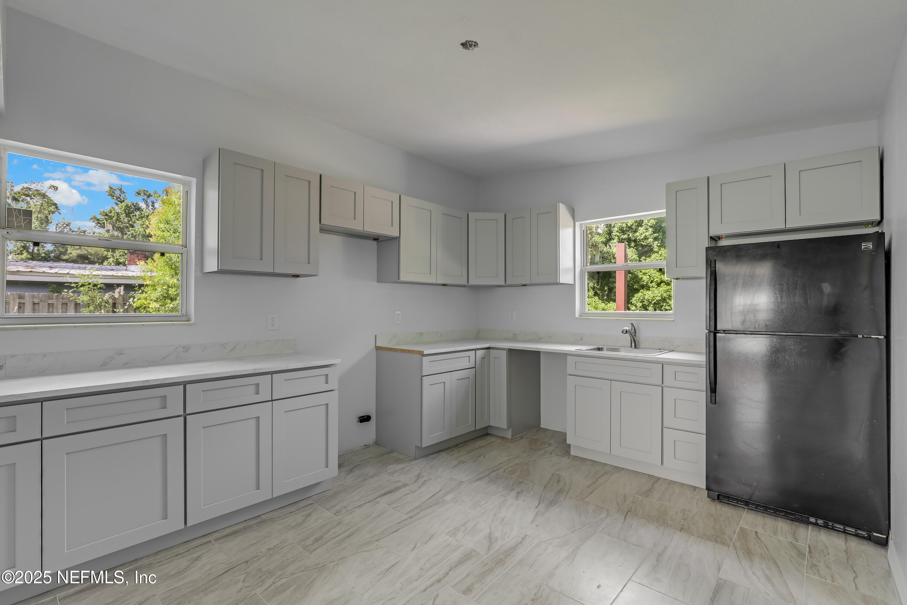 10524 Rutgers Road Jacksonville, FL 32218 - Photo 17 of 46 a kitchen with a white cabinets and refrigerator