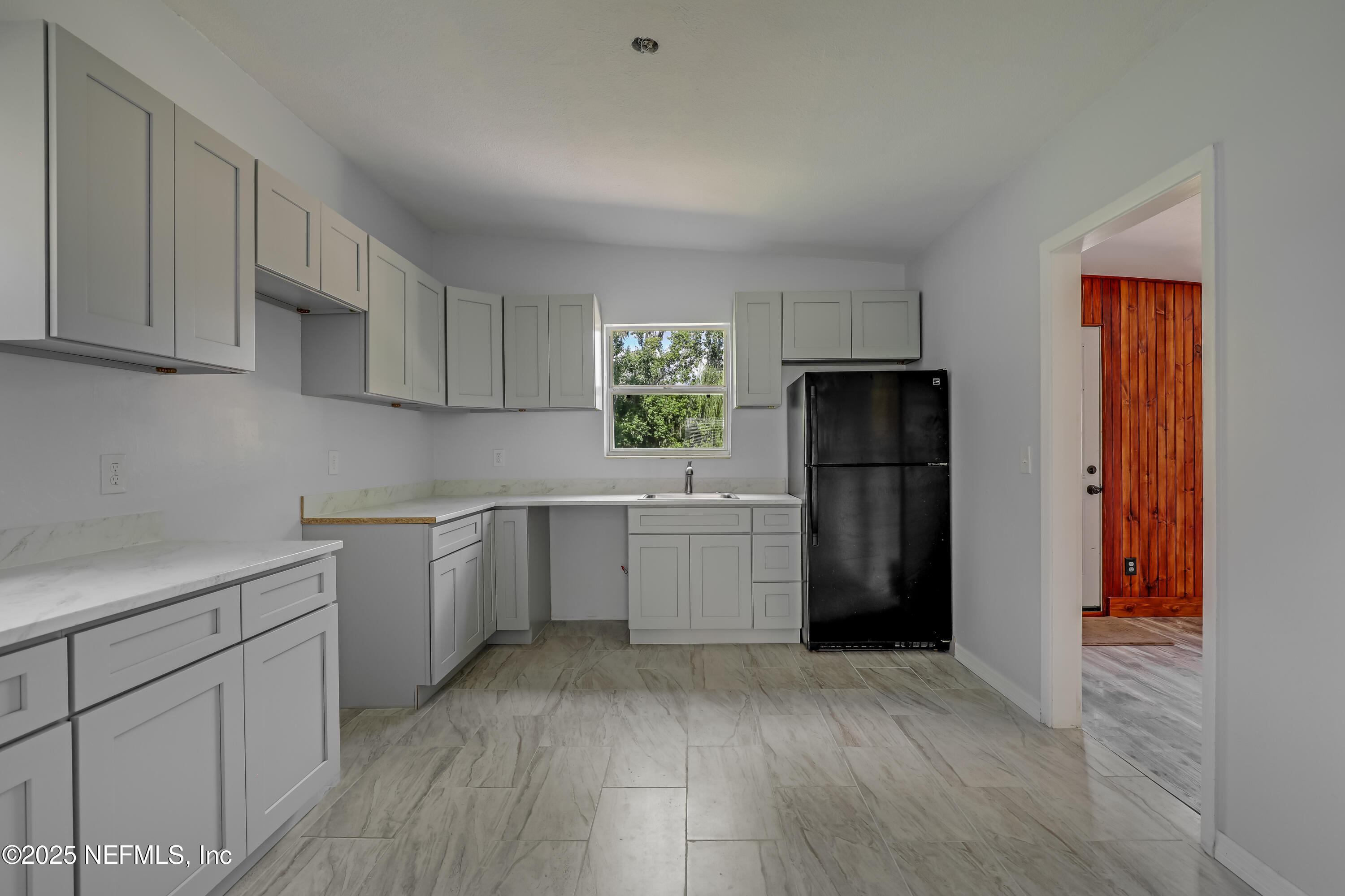 10524 Rutgers Road Jacksonville, FL 32218 - Photo 18 of 46 a kitchen with a refrigerator and a sink