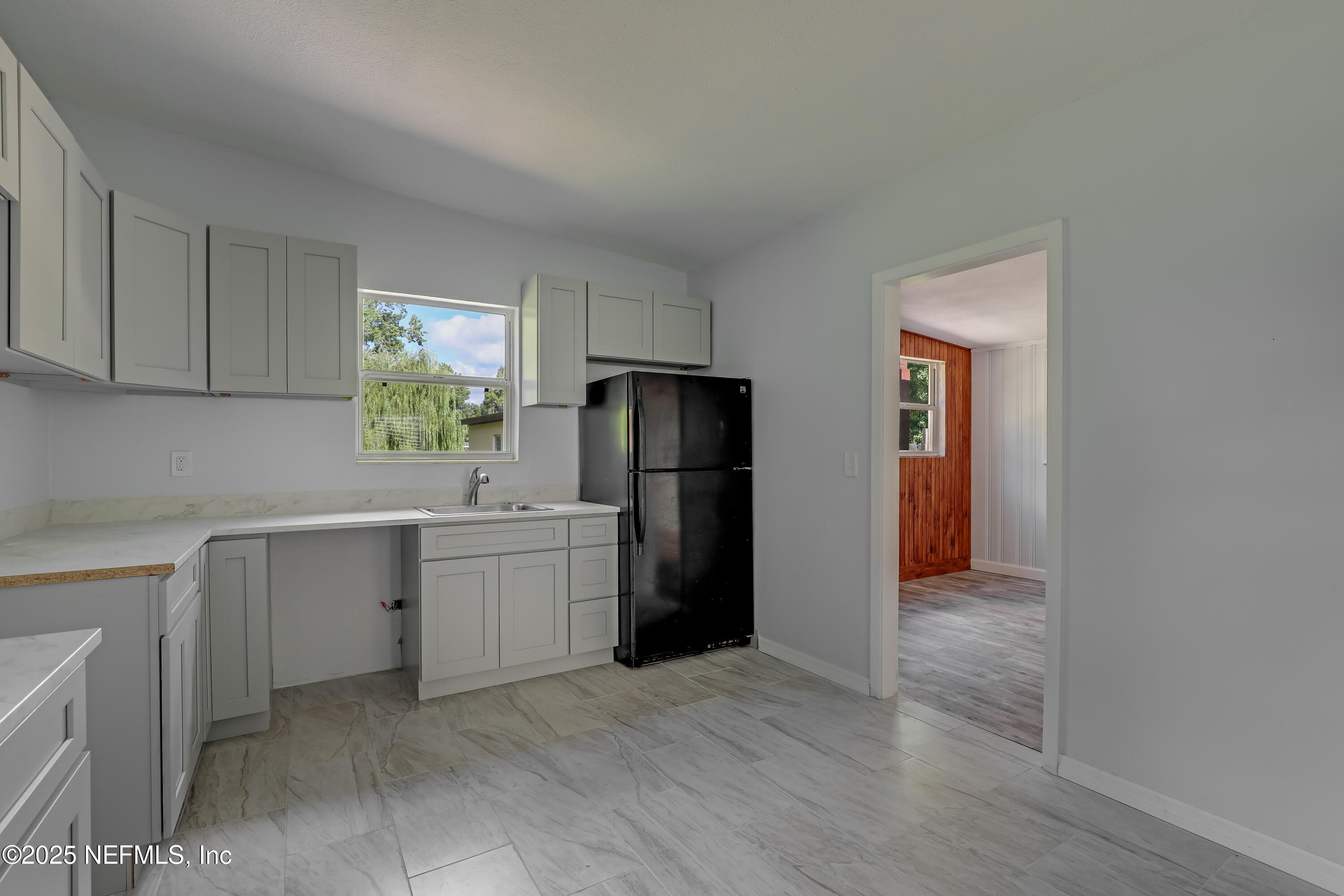 10524 Rutgers Road Jacksonville, FL 32218 - Photo 19 of 46 a kitchen with a refrigerator and a sink