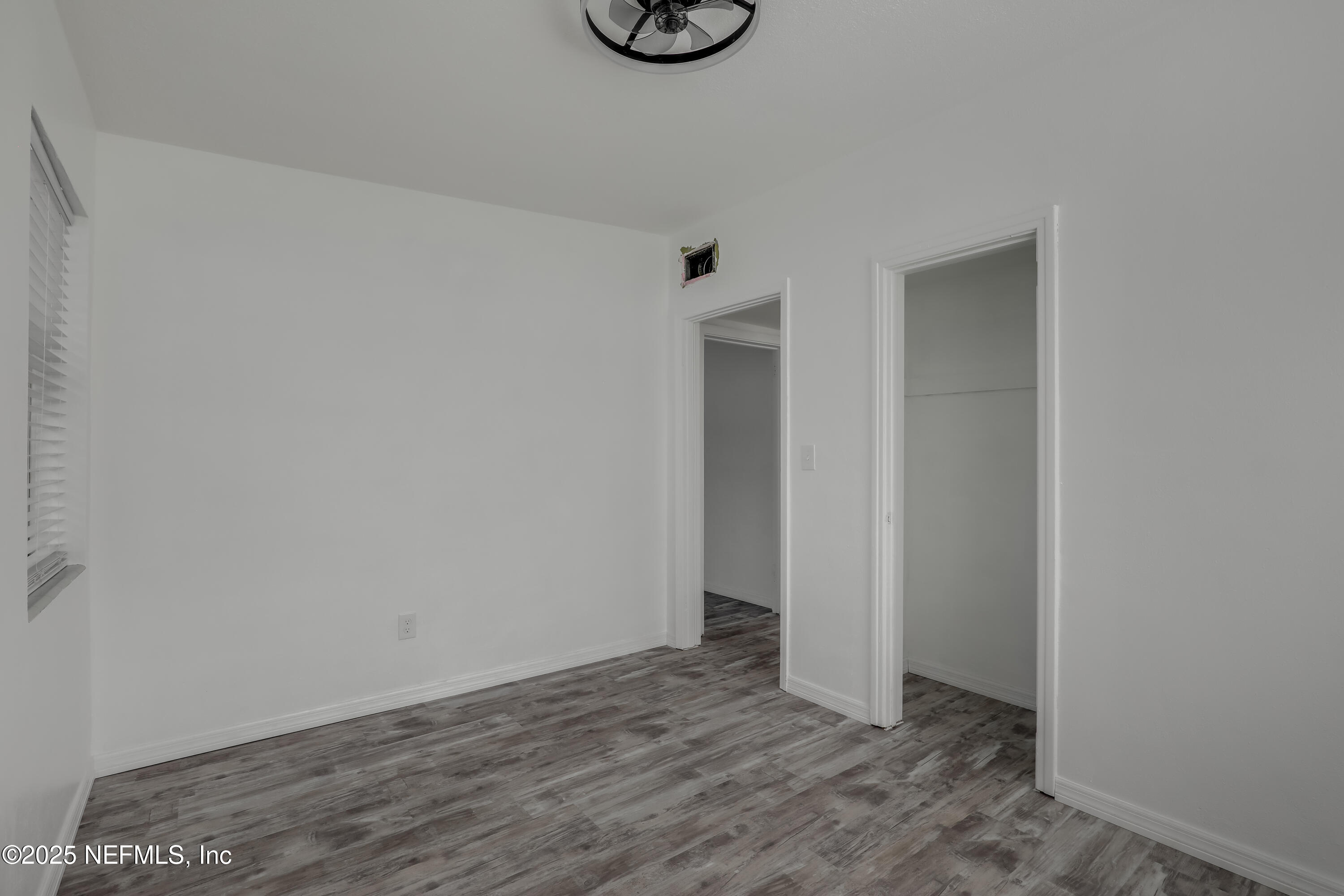 10524 Rutgers Road Jacksonville, FL 32218 - Photo 34 of 46 a view of an empty room with wooden floor and a window