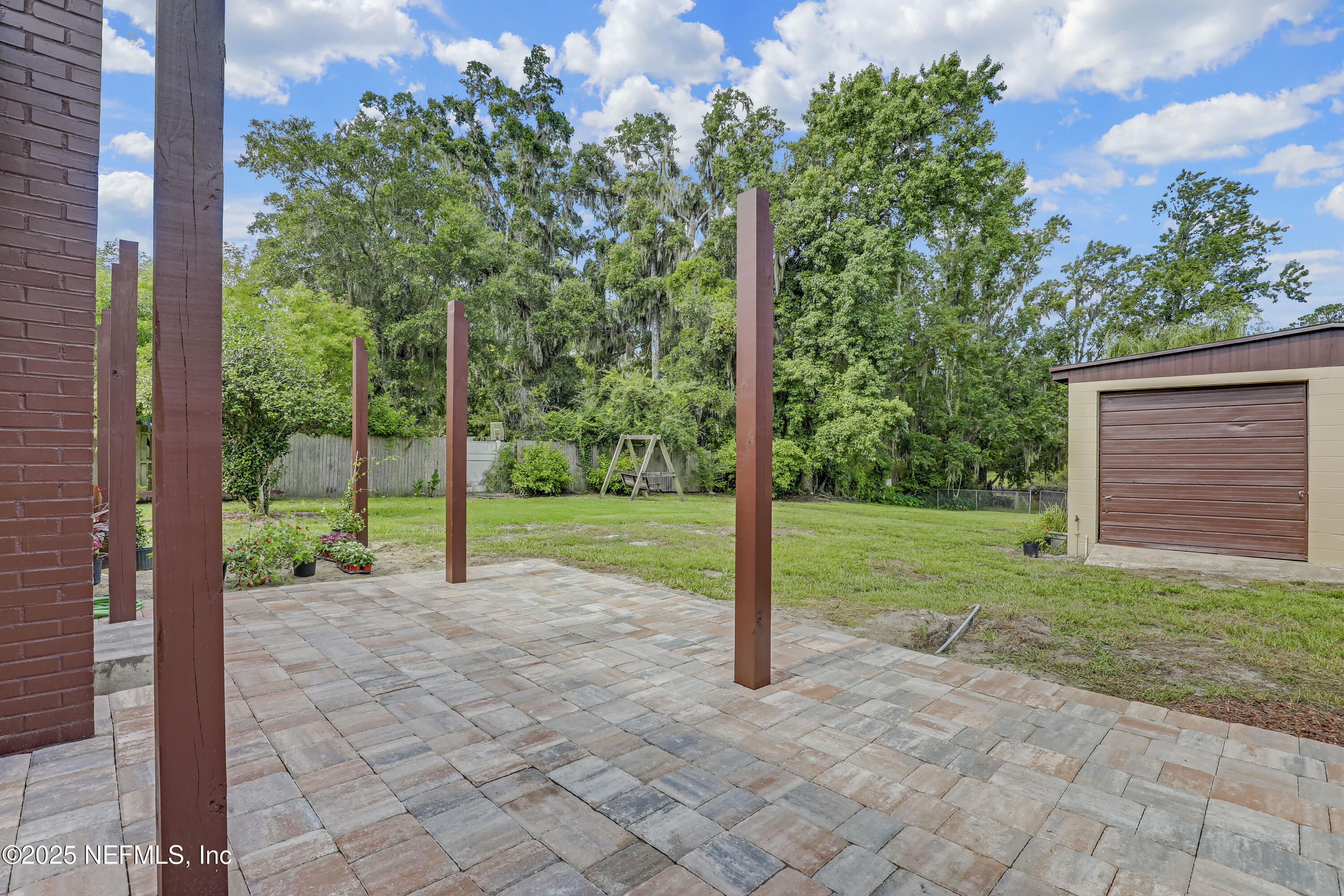 10524 Rutgers Road Jacksonville, FL 32218 - Photo 36 of 46 a view of a yard with a house and large trees