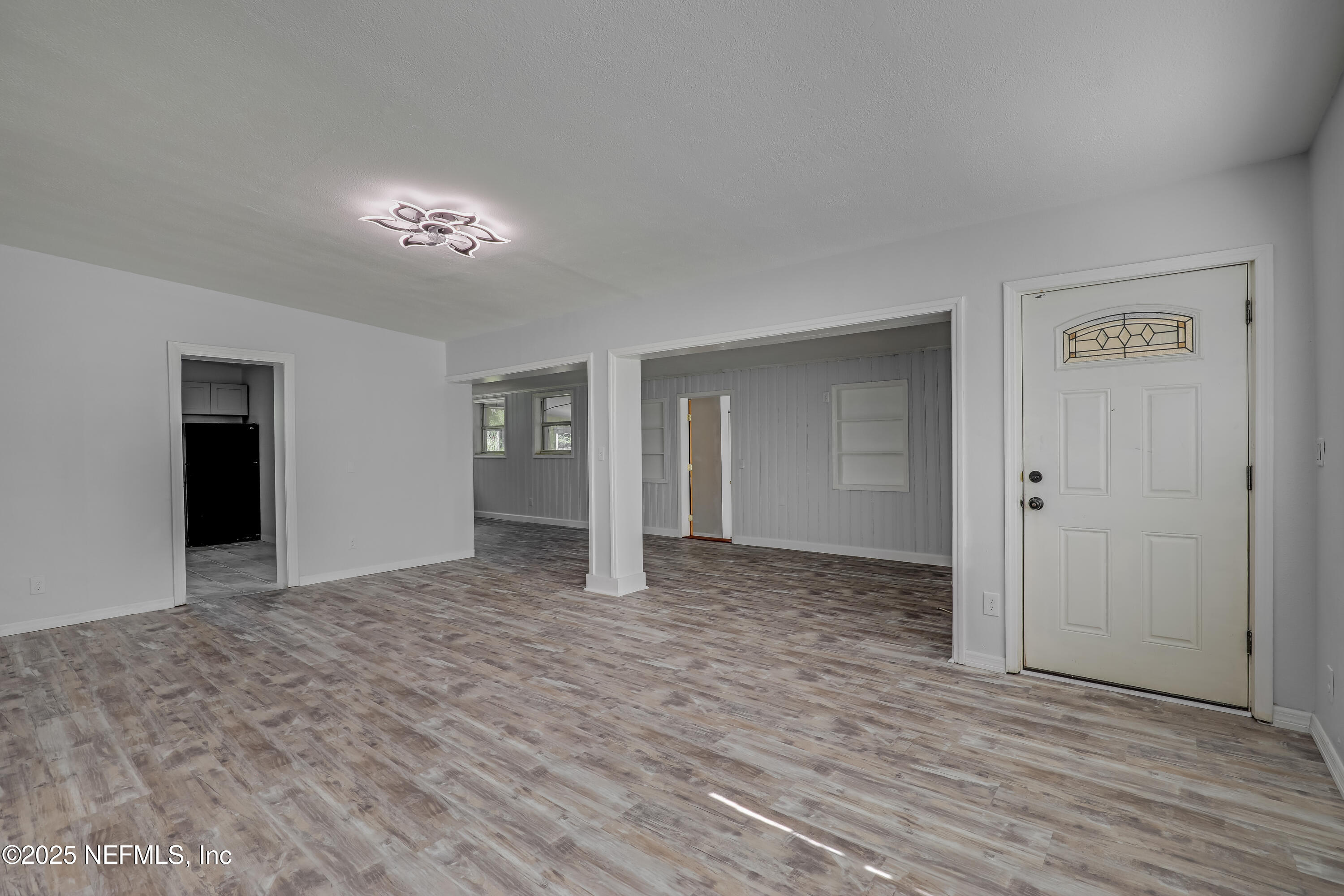 10524 Rutgers Road Jacksonville, FL 32218 - Photo 10 of 46 a view of an empty room with window and wooden floor