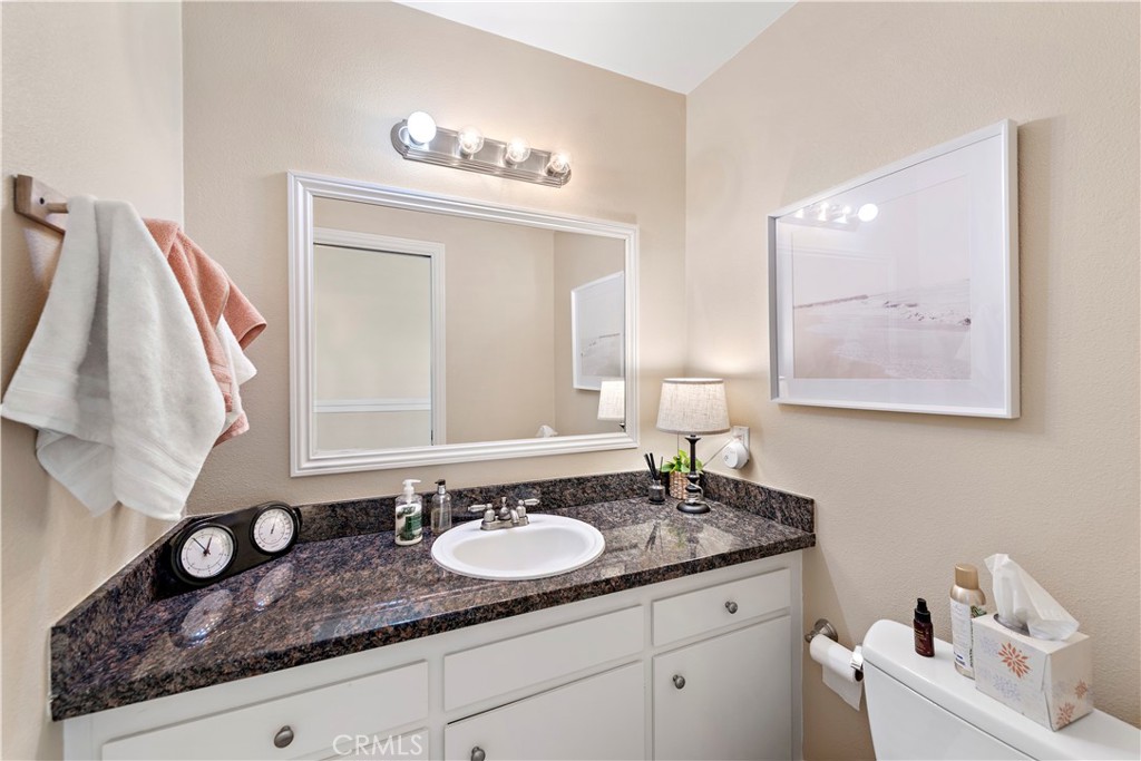 34081 Colegio Drive Dana Point, CA 92629 - Photo 12 of 34 a bathroom with a granite countertop sink and a mirror