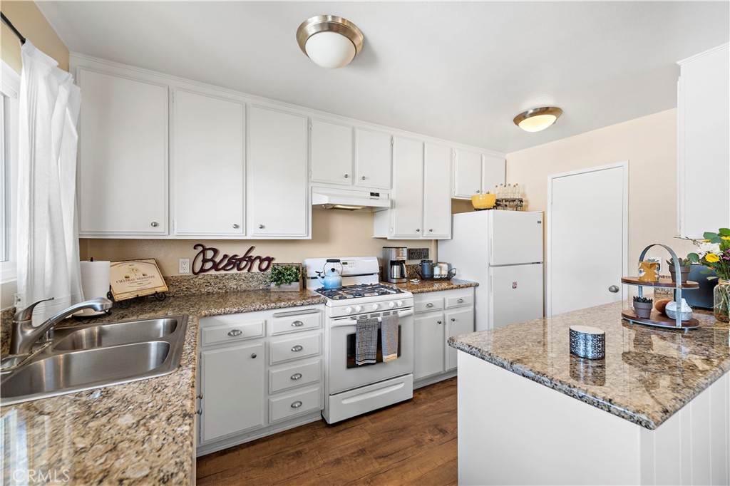 34081 Colegio Drive Dana Point, CA 92629 - Photo 23 of 34 a kitchen with granite countertop a sink stainless steel appliances and white cabinets