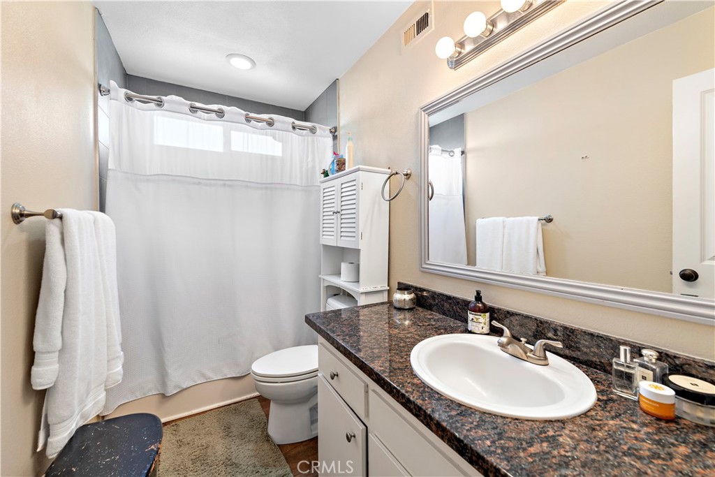 34081 Colegio Drive Dana Point, CA 92629 - Photo 10 of 34 a bathroom with a granite countertop sink toilet and shower
