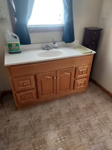 a bathroom with a tub a sink and a shower
