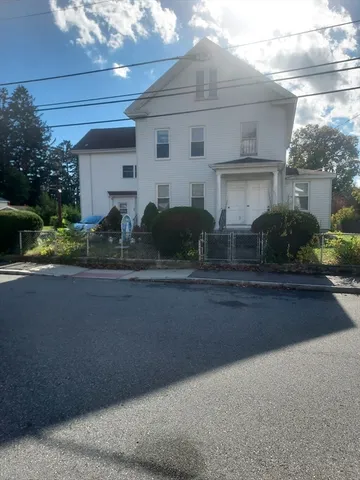a front view of a house with a yard and a garage