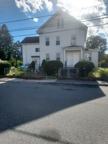 a view of a garden with large trees