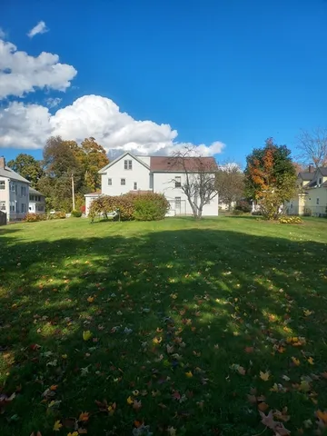 a view of a big yard with large trees