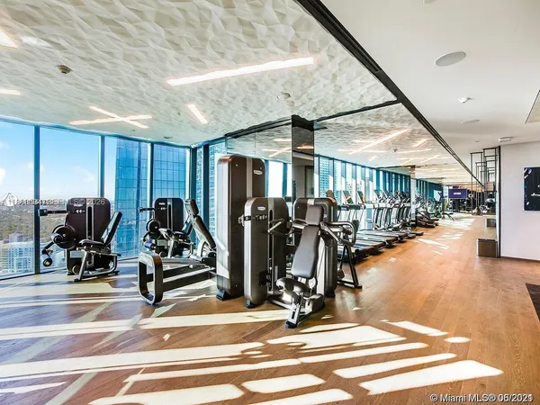 a room with gym equipment and a large window