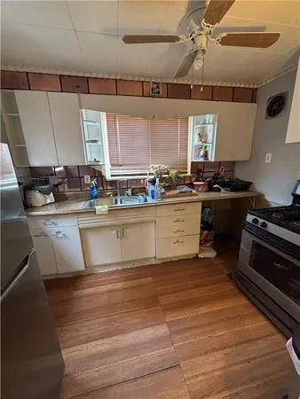 a large kitchen with stainless steel appliances granite countertop a sink stove and refrigerator